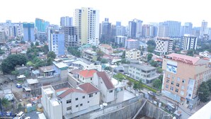 A cityscape with high-rise buildings, a mix of residential and commercial structures, and a prominent commercial center. - yellow apple hotel (Addis Ababa)