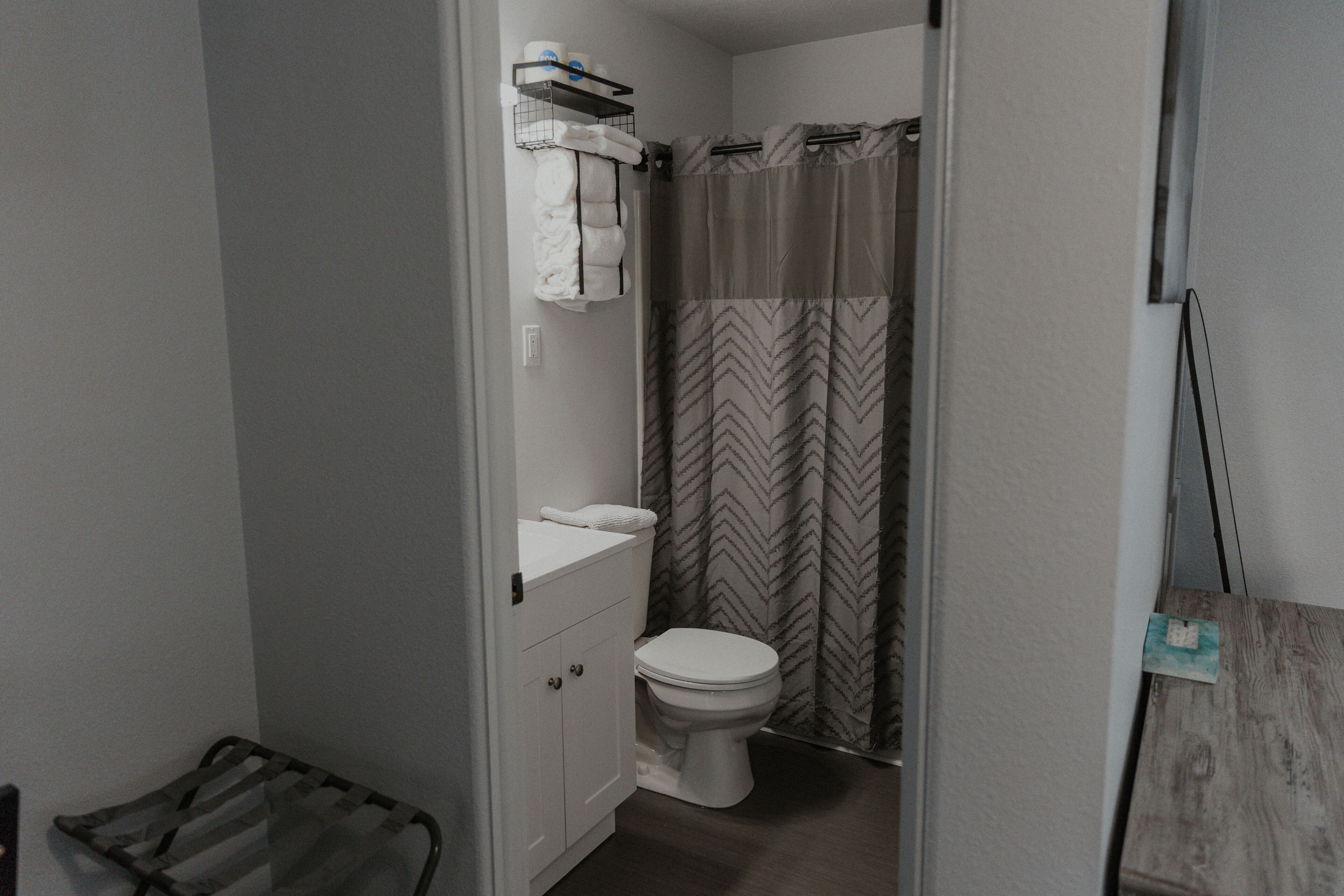 Combined shower/bathtub, towels, soap, toilet paper