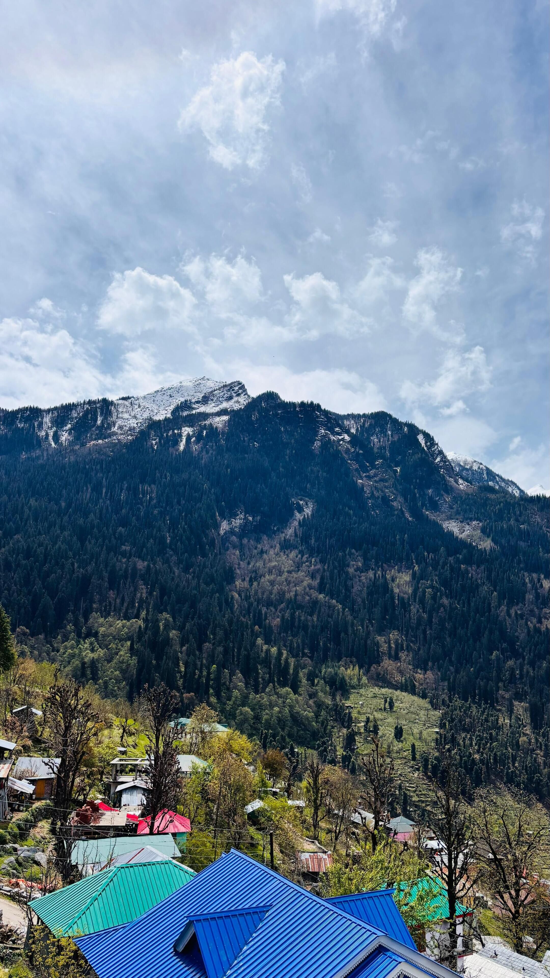 A mountainous landscape with a village in the foreground.