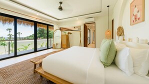 A bedroom with a large bed, a wooden bench, a mirror, and a view of the outdoors. - Villa Svara - 4BR Villa w/ Panoramic Ocean Views (Purwakerti)