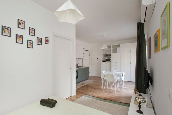 A modern interior with a dining area, kitchen, and living space.