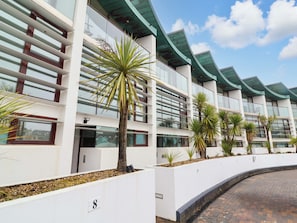 A modern building with white walls, multiple windows, and a curved roof. - 12 Nautilus (Bideford)