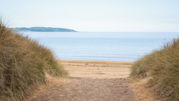 A beach path leading to the sea with a distant landmass. - Mellebyrundan by Interhome (Mellbystrand)