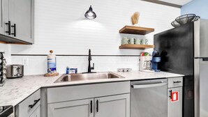A modern kitchen with a stainless steel refrigerator, a coffee machine, and a sink. - ☀️Walk to Beach | 4 Pools | Horizon South 59-104☀️ (Panama City Beach)