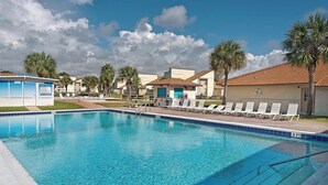 A clear swimming pool with lounge chairs and palm trees. - ☀️Walk to Beach | 4 Pools | Horizon South 59-104☀️ (Panama City Beach)