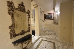 An ornate mirror, a marble staircase, and a framed artwork in a hallway. - Exclusive luxury penthouse located in Piazza D’Azeglio in Viareggio, on the third floor with elevator, featuring high-end finishes and a stunning panoramic sea-view terrace.The apartment, approximately 110 sqm, is arranged over two levels and enhanced  (Viareggio)
