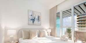 A modern hotel room with a large bed, a view of the city, and a balcony with a unique architectural design. - LUX  The Grand Bleu Suite 2 (Dubai)