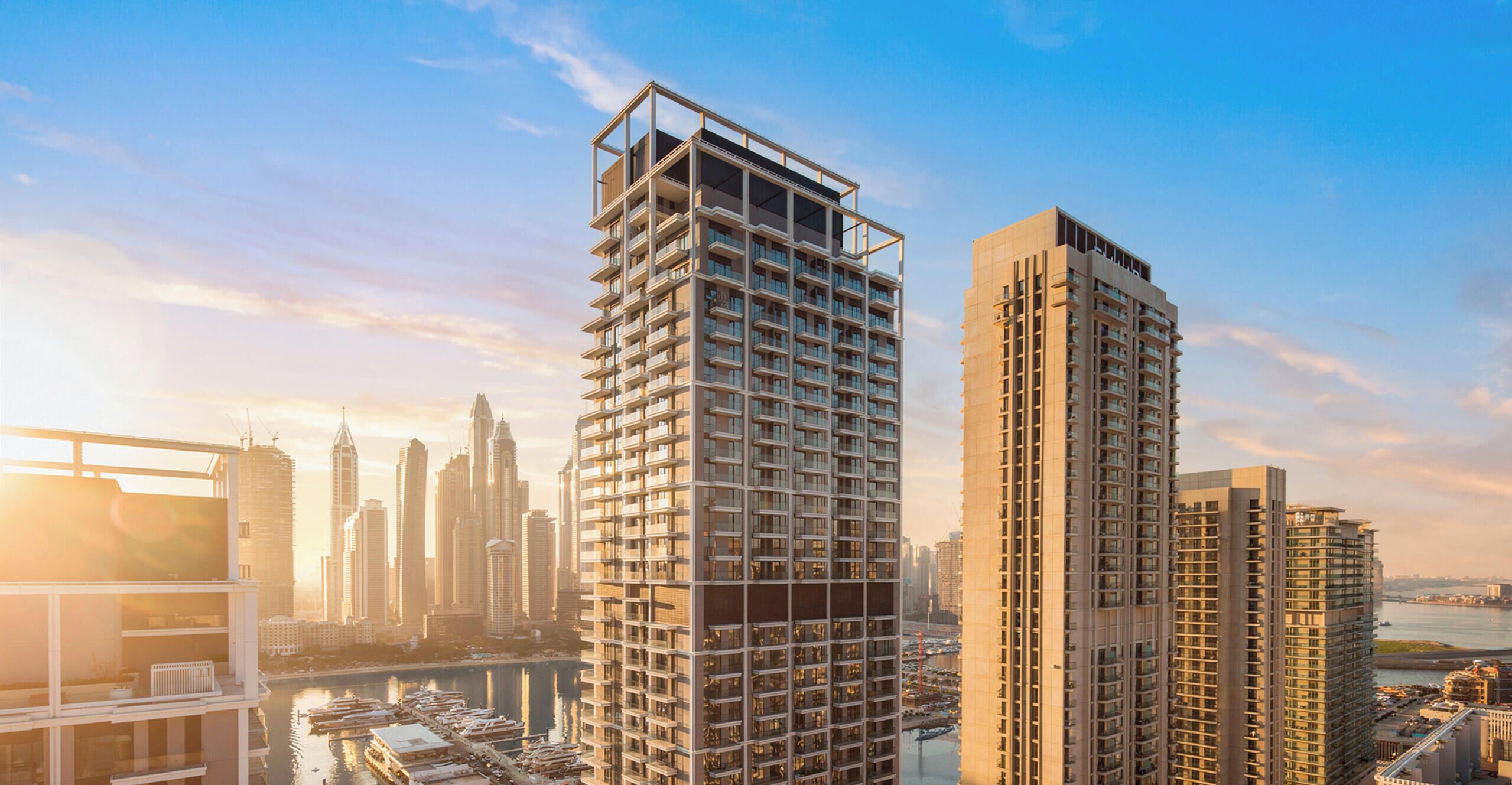 A high-rise building with multiple floors, a modern architectural design, and a view of the city skyline in the background.