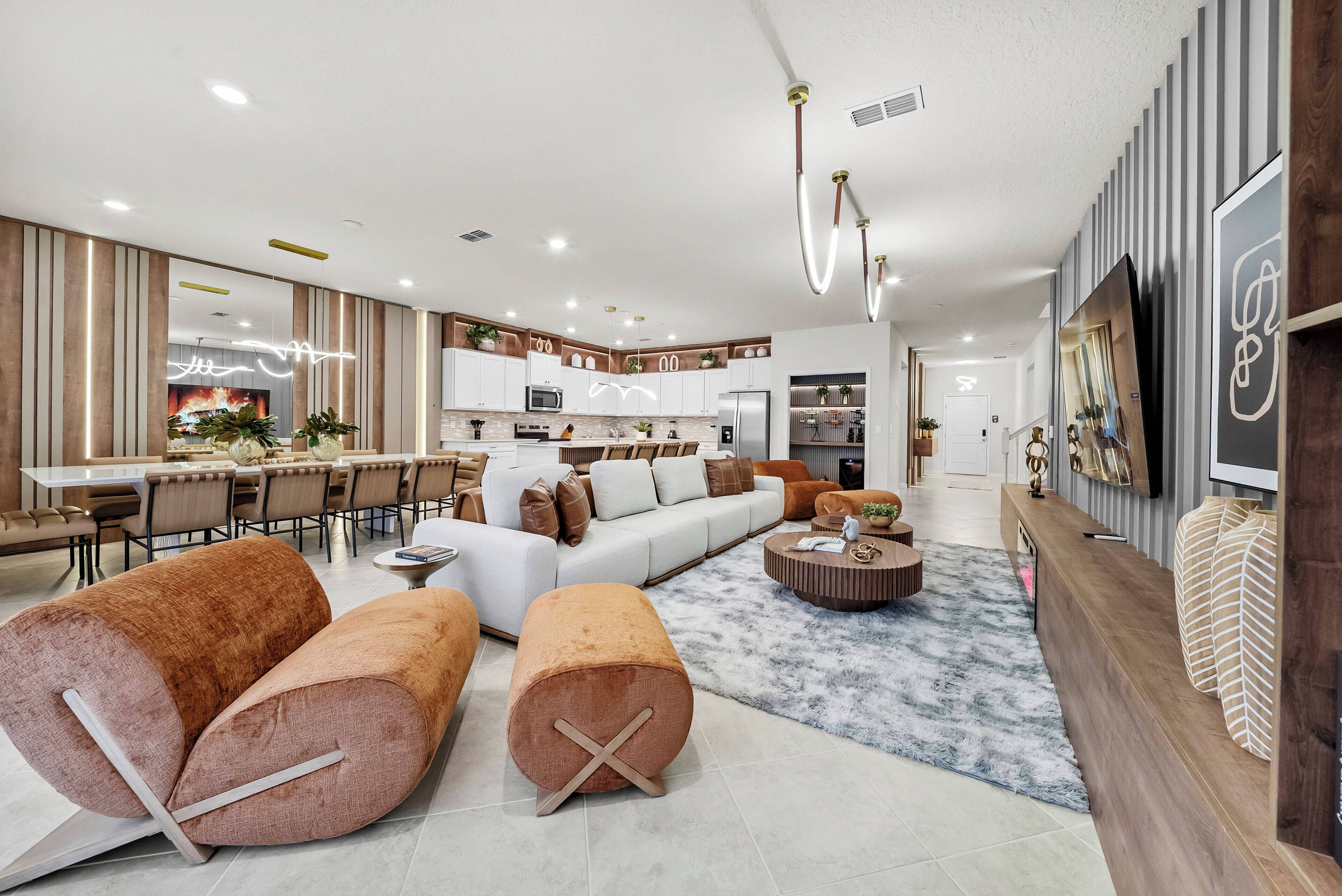A modern living room with a sofa, ottomans, and a coffee table.