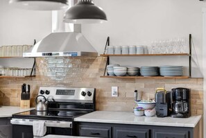 Custom range hood, tile backsplash, and open shelving - Bike garage, game room, near downtown (Bentonville)