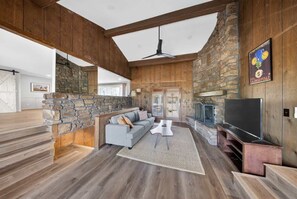 Stunning main living room with vaulted beams, stone fireplace, and warm wood walls - Bike garage, game room, near downtown (Bentonville)