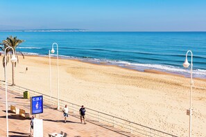 A beach with a clear sky, a boardwalk, and a sign with 'CGI' on it. - Apartamentos Turisticos Rent Guardamar (Guardamar del Segura)