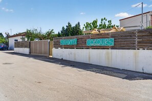 A gated entrance with a sign that reads 'SOVOTA COLOURS.' - Studio Apartment 'Sivota Colours 22' with Private Terrace, Wi-Fi and Air Conditioning (Sivota)