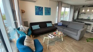 A modern living room with a sofa, armchairs, and a coffee table.