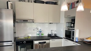 A modern kitchen with stainless steel appliances, a dishwasher, and a microwave.