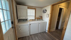A laundry room with a washing machine, dryer, and a sign that reads 'Laundry Room.'