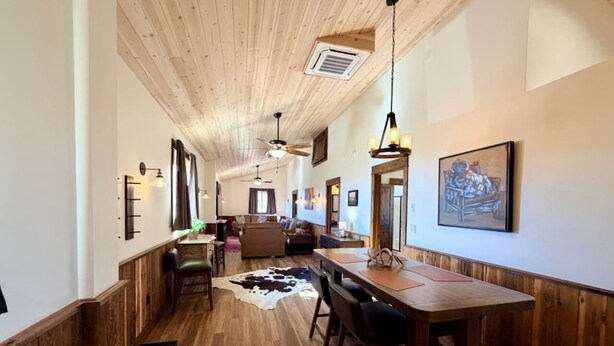 A wooden interior with a dining area, kitchen, and living space. - Elk Suite: Epic Paradise Valley Views will amaze. (Emigrant)