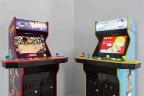 Two arcade machines with screens displaying games, buttons, and joysticks. - 3KingBeds_Sleeps7_Arcade_Perfect for FIFA WC 26 (Overland Park)