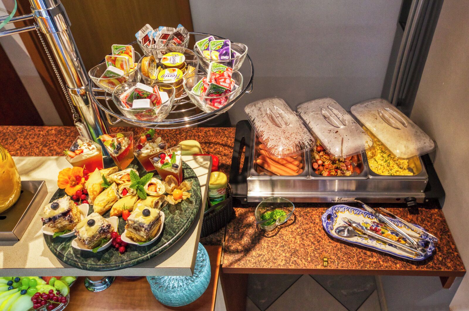 A buffet with various food items and a coffee station.