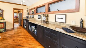 A kitchen with wooden cabinets, granite countertops, and a built-in oven.