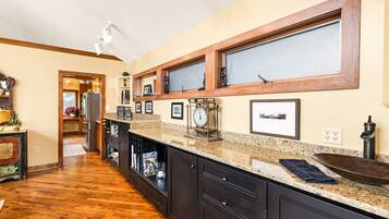 A kitchen with wooden cabinets, granite countertops, and a built-in oven.