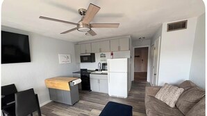 A compact living space with a kitchenette, a dining area, a seating area, and a ceiling fan. - Lake front 1-bedroom condo in charming Osage Beach convenient location (Osage Beach)