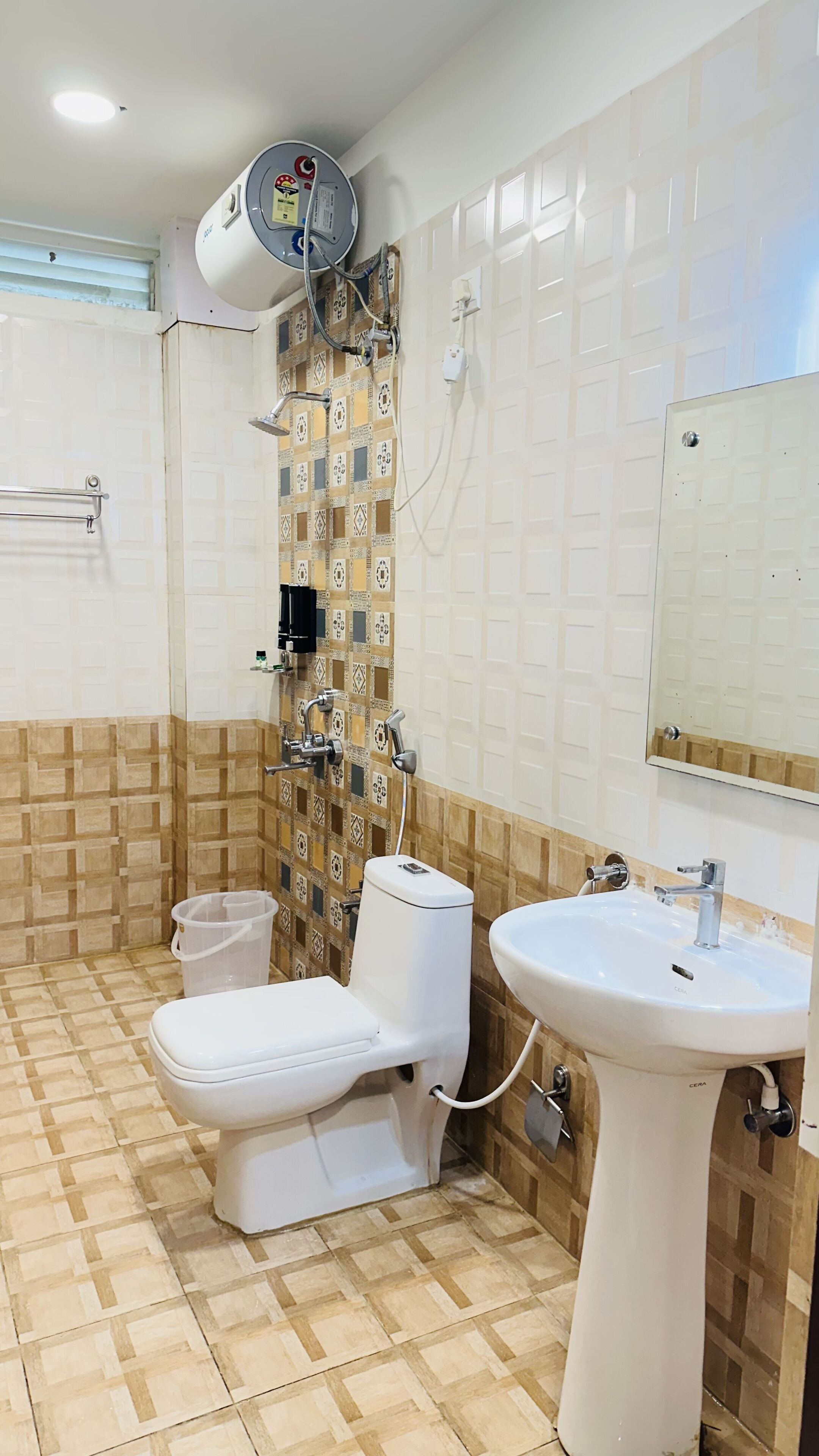 A bathroom with a toilet, bidet, shower, and sink.