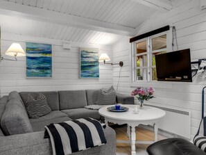 A modern living room with a gray sofa, two wall-mounted lamps, and a flat-screen TV. - "Jalina" - 30km from the sea by Interhome (Toftlund)