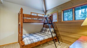 Bedroom featuring wooden bunk beds and wood-paneled walls. - 5 Bedrooms - 12 SHARC Passes- Hot Tub - Bikes- Dog (Sunriver)