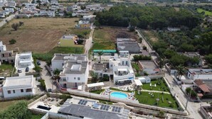An aerial view of a residential area with houses, a swimming pool, and solar panels. - Diletta's Residence - Two-room apartment 2 (Sant'Isidoro)