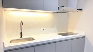 A modern kitchen with a stainless steel sink, a faucet, and a countertop. - Modern loft City Bog Usaquén (Bogotá)
