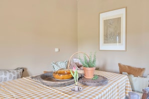 A checkered table with a potted plant, a ceramic bowl, and a rustic wooden tray. - 6bed Somerset Country Escape- Walk, Relax, Explore (Shepton Mallet)
