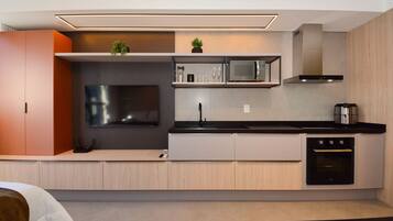 A modern kitchen with a built-in microwave, oven, and sink.