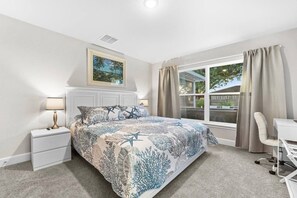 A bedroom with a bed, nightstands, a desk, and a window with curtains. - NEW Luxury Build + Private Saltwater Pool & Spa (Venice)