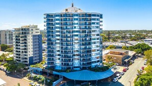 A multi-story hotel with balconies, a covered entrance, and a view of the surrounding urban area. - Centrepoint Unit 58, 30 Minchinton Street, Calound (Caloundra)