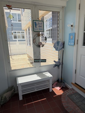 A room with a large window, a bench, a wall-mounted fan, and a decorative seahorse sign. - Beautiful 3-bedroom bay side house with AC in charming Lavallette (Lavallette)