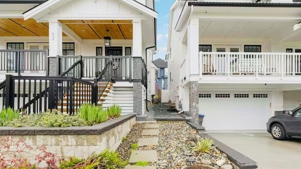 A residential building with a covered porch, a staircase, and a driveway. - Bright 2BR Suite Near White Rock & Vancouver (Surrey)