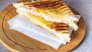 A grilled sandwich on a wooden board. - Container Black  (Rio de Janeiro)