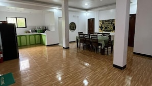 Quarto amplo com área de jantar, cozinha e uma parede decorada com tema de Ano Novo 2026.