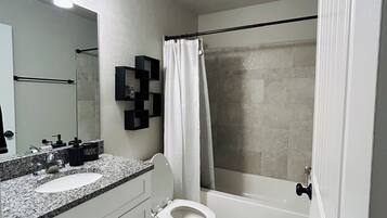 Shower, hair dryer, towels, toilet paper