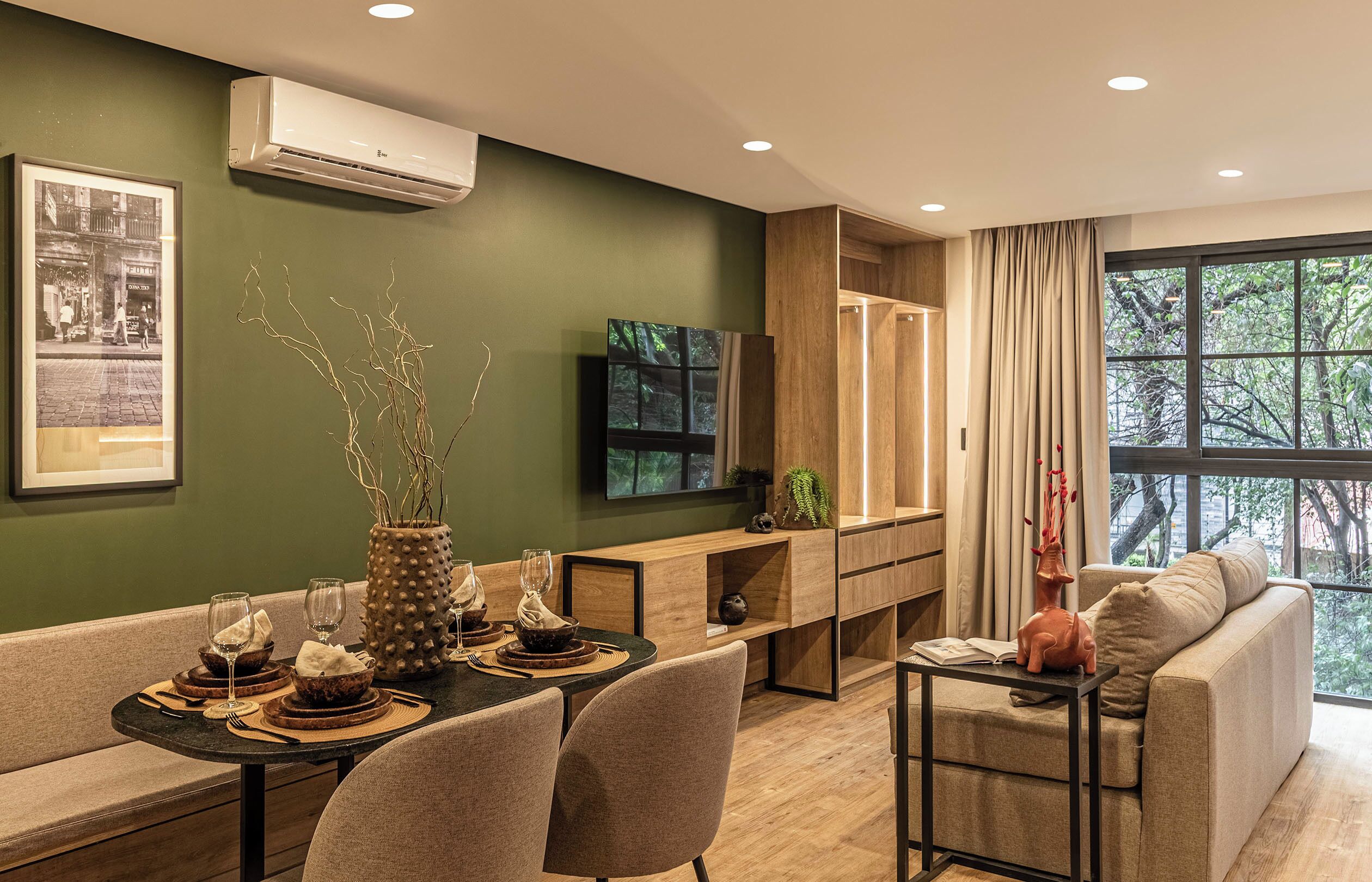 A modern living room with a dining area, a sofa, a TV, and a large window with a view.