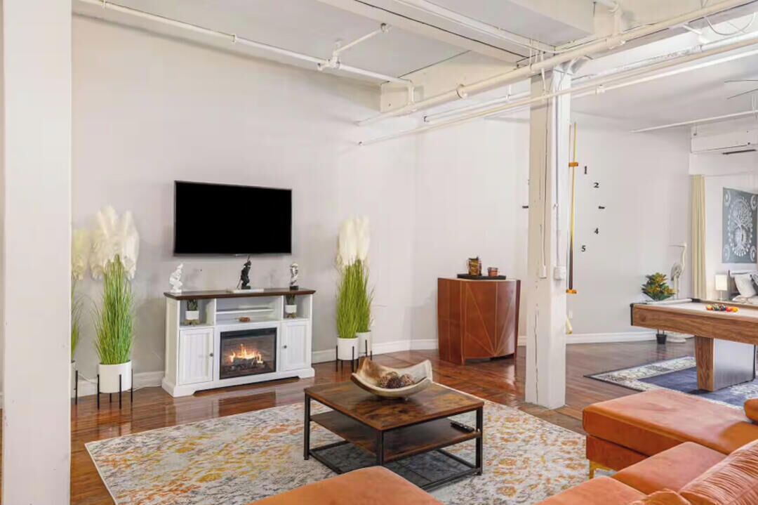 A modern living room with a fireplace, television, and seating area.