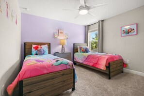 A bedroom with two beds, a ceiling fan, and a window with curtains. - The Ultimate Private Oasis & Game Room 6 BD/ 3.5 BA/ Solterra Resort (5140 OA) (Davenport)