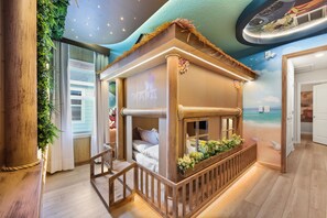 A room with a beach-themed playhouse, a wooden railing, and a view of the sea through a window. - 8 BD/ 6 BA/ Windsor Cay (1025 BW) (Clermont)