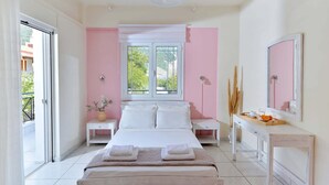 A bedroom with a bed, bedside tables, a dresser, a mirror, and a window with a view.