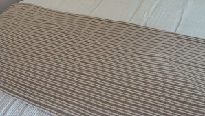 A neatly made bed with striped pillows, a wooden headboard, and a bedside lamp. - Holiday rental near La Tranche sur mer (La Jonchère)