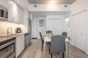 Fridge, microwave, oven, stovetop - Modern Industrial 1BR + Balcony in Old Montreal (Montreal)