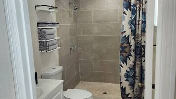 Shower, towels, soap, toilet paper