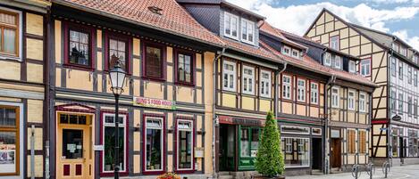 A row of traditional half-timbered buildings with a cobblestone street.