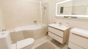 A modern bathroom with a shower, toilet, and vanity. - Morning in Prague – Cozy Entire Home for 15, 1 min to Tram, 4 Rooms & 2 Kitchens (Praha2)